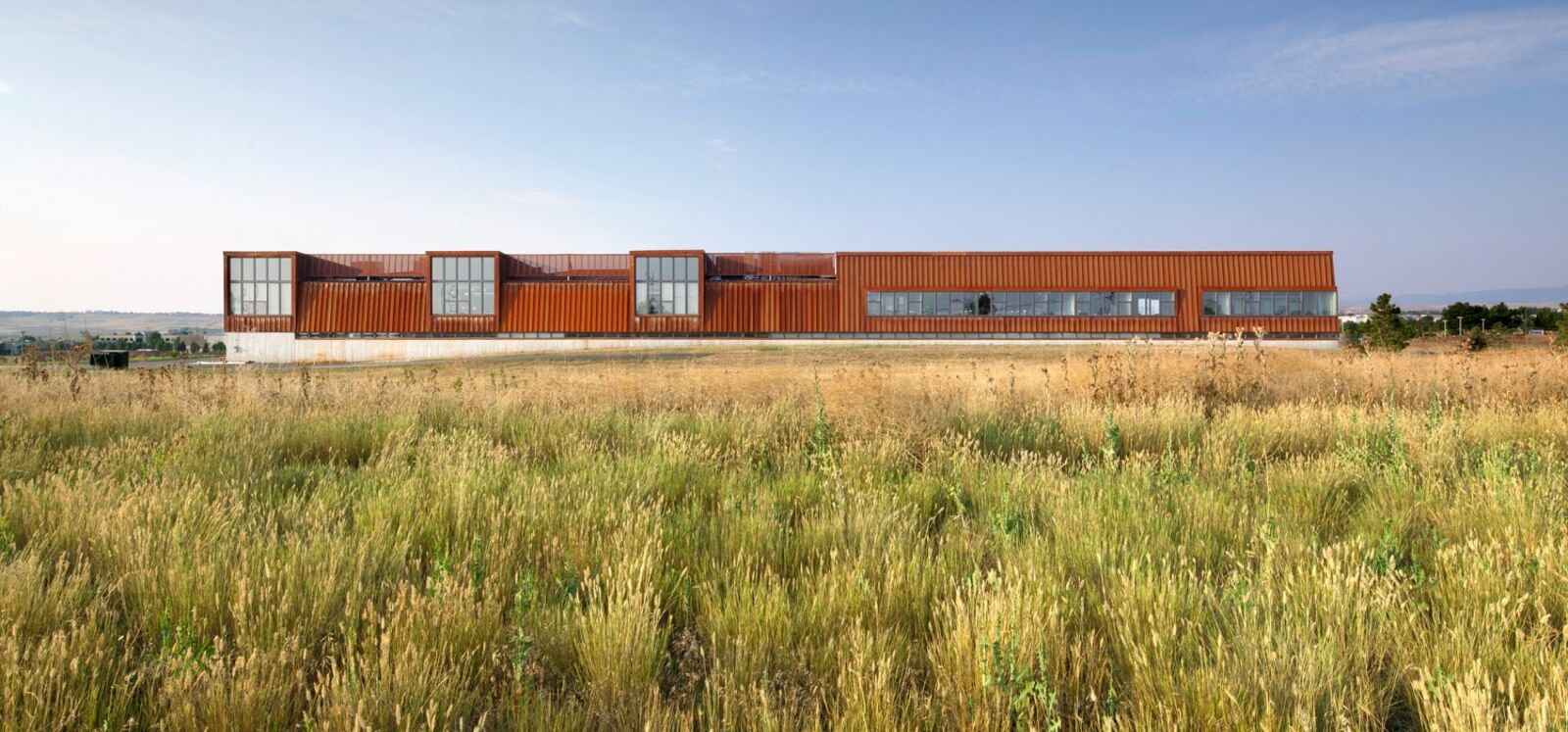 View of the building's exterior façade in a field of grass