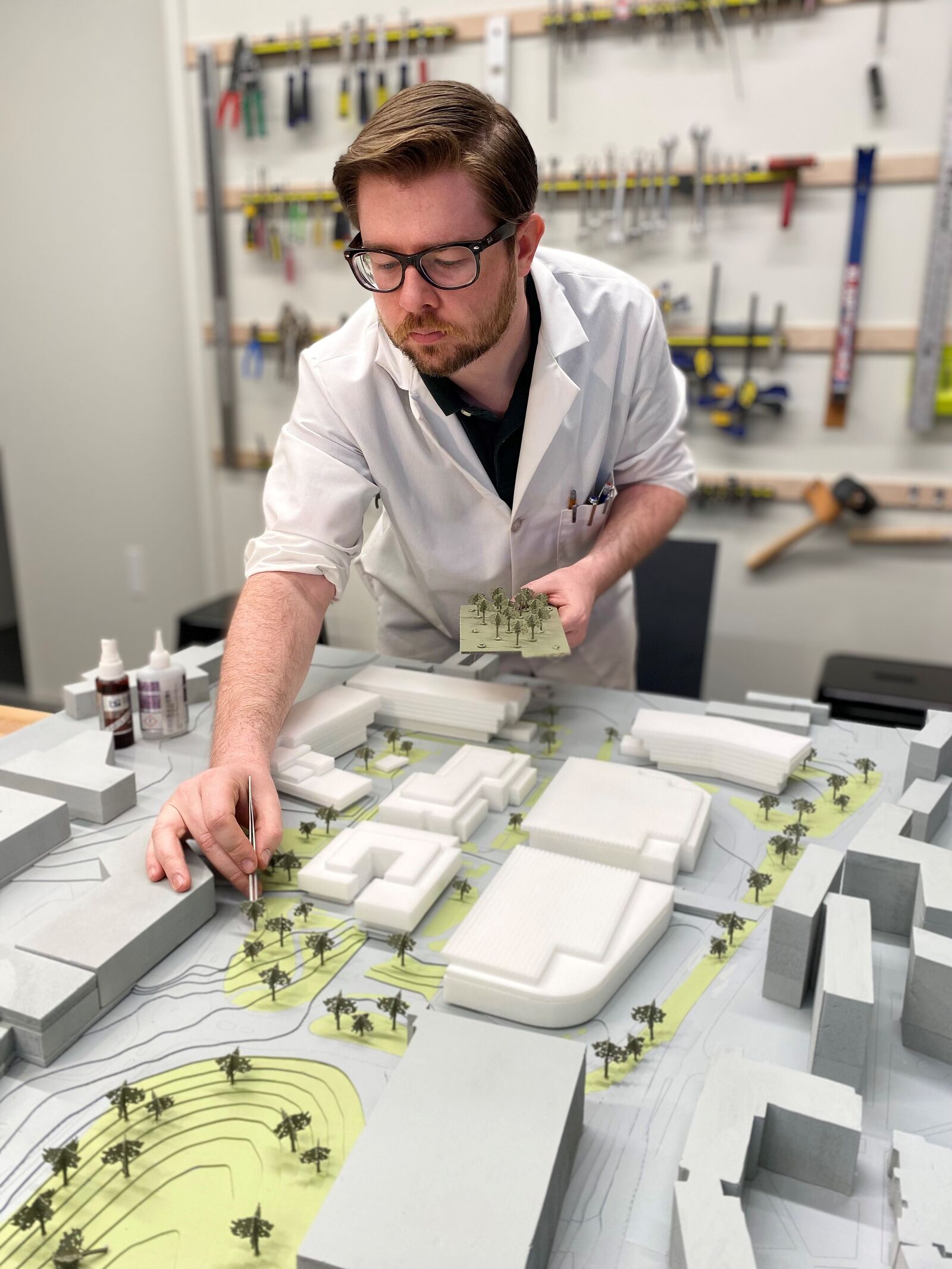 Man working on details of an architectural model 