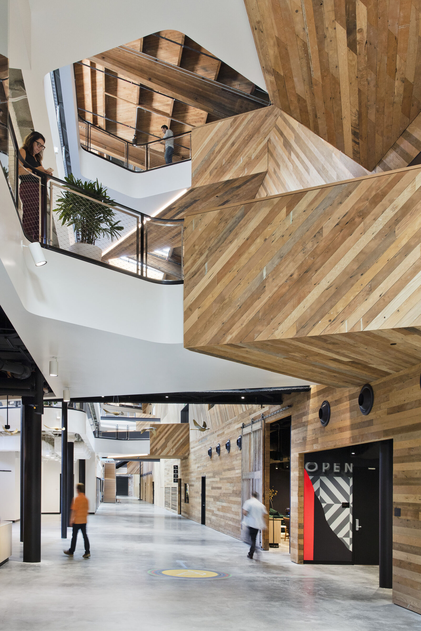 interior hallway space with multilevel view of people interacting with space.