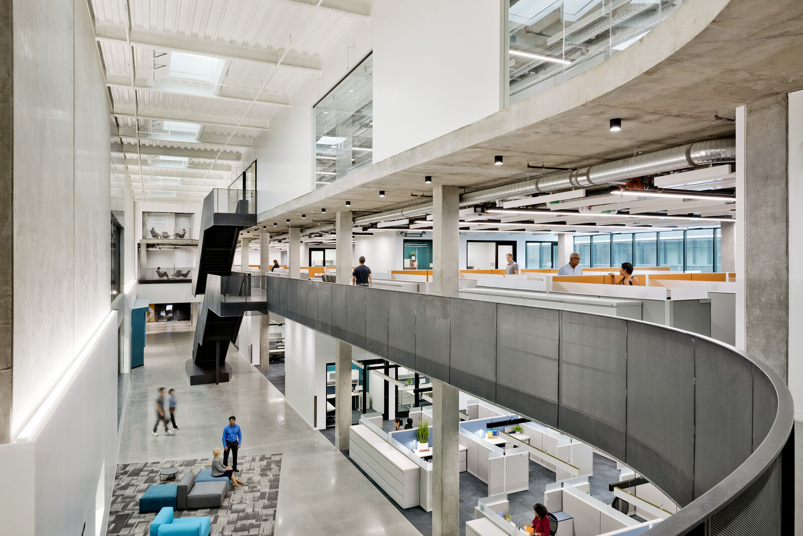 Concrete interior of the facility with office space wrapping around an atrium. 