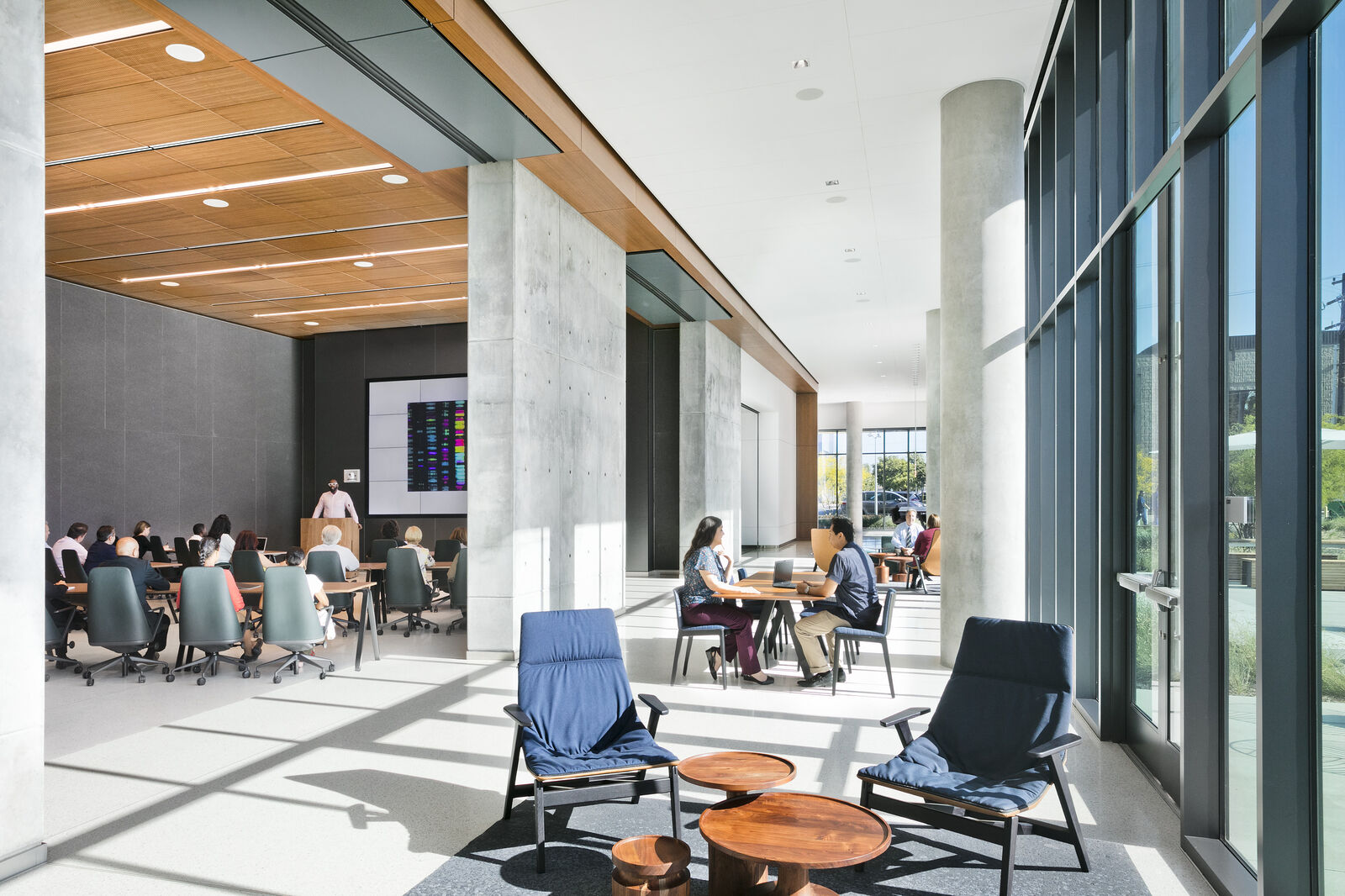 Interior conference area and lounge space with people sitting 
