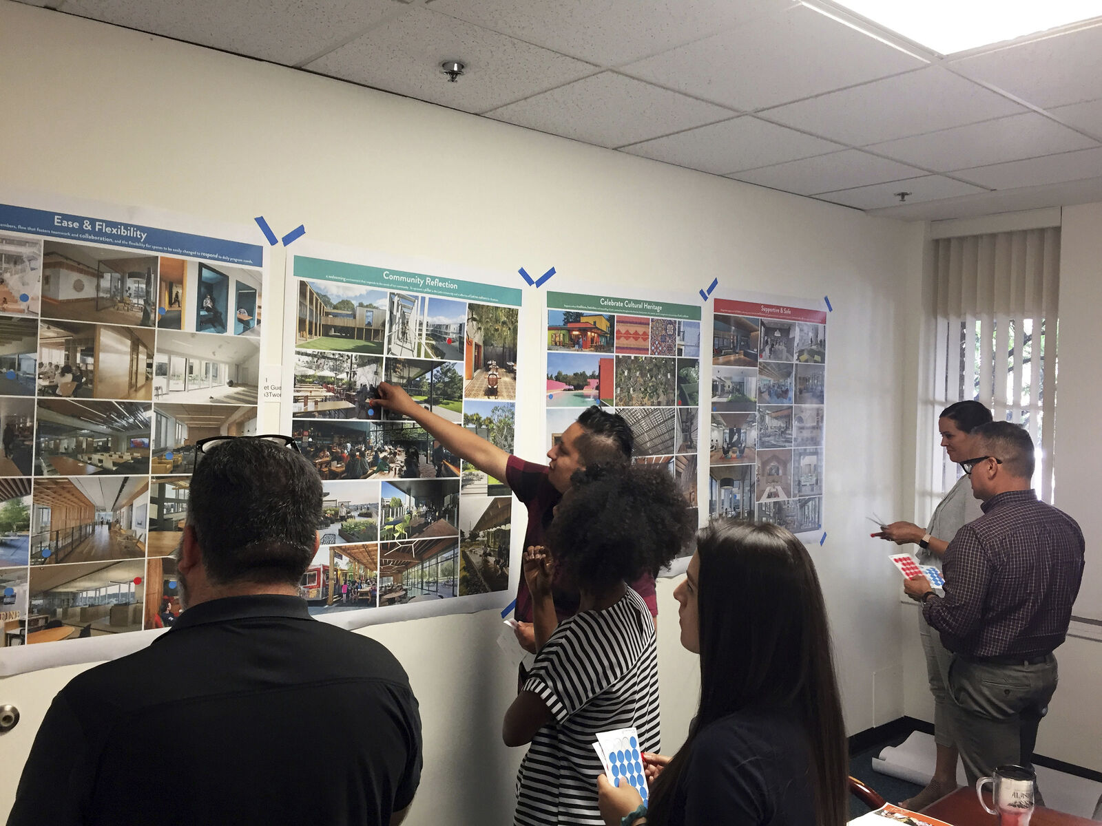 People reviewing design plans for La Plaza Esperanza