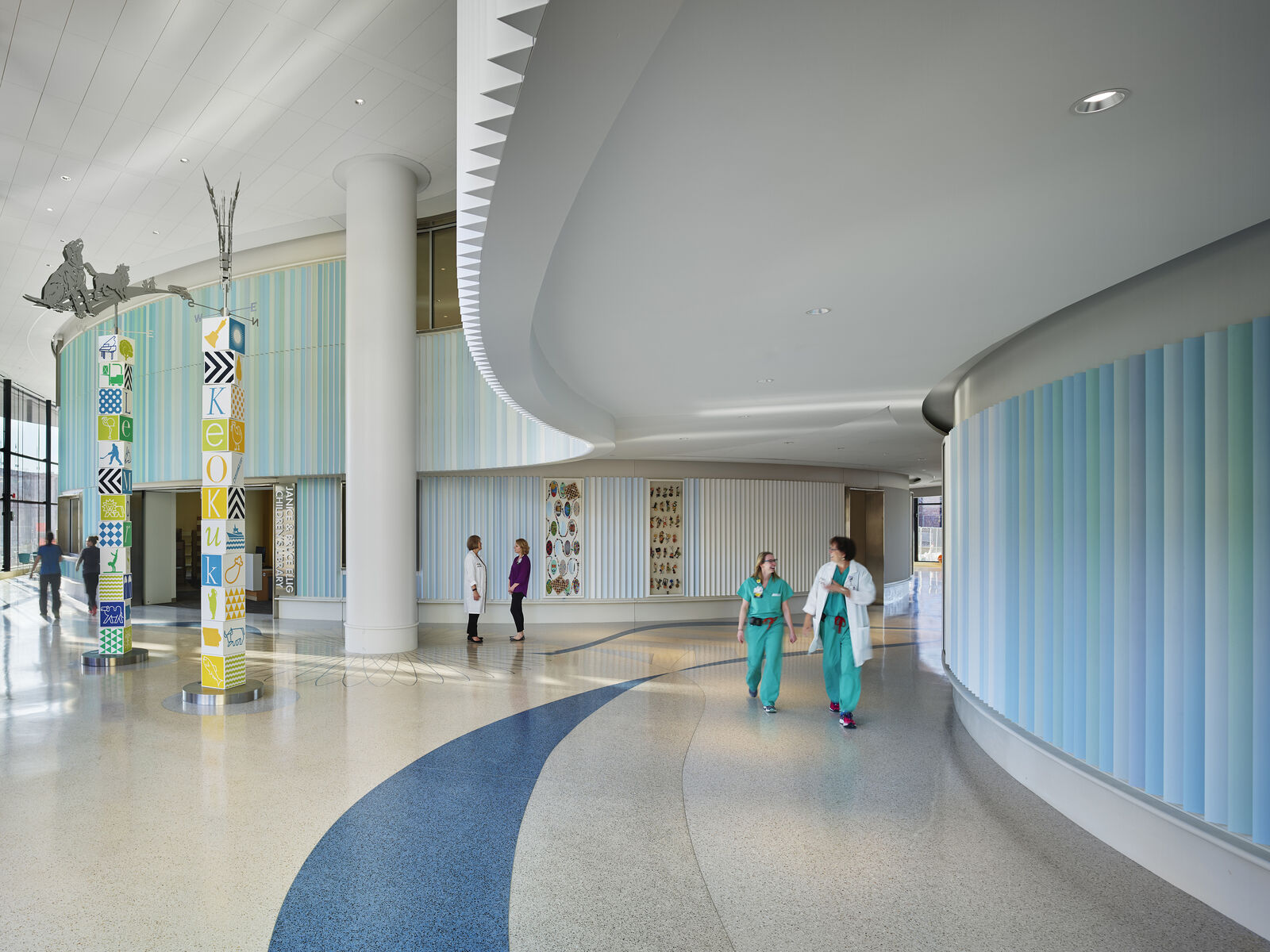 Nurses and doctors walking through the lobby of Iowa Children's Stead Family Hospital