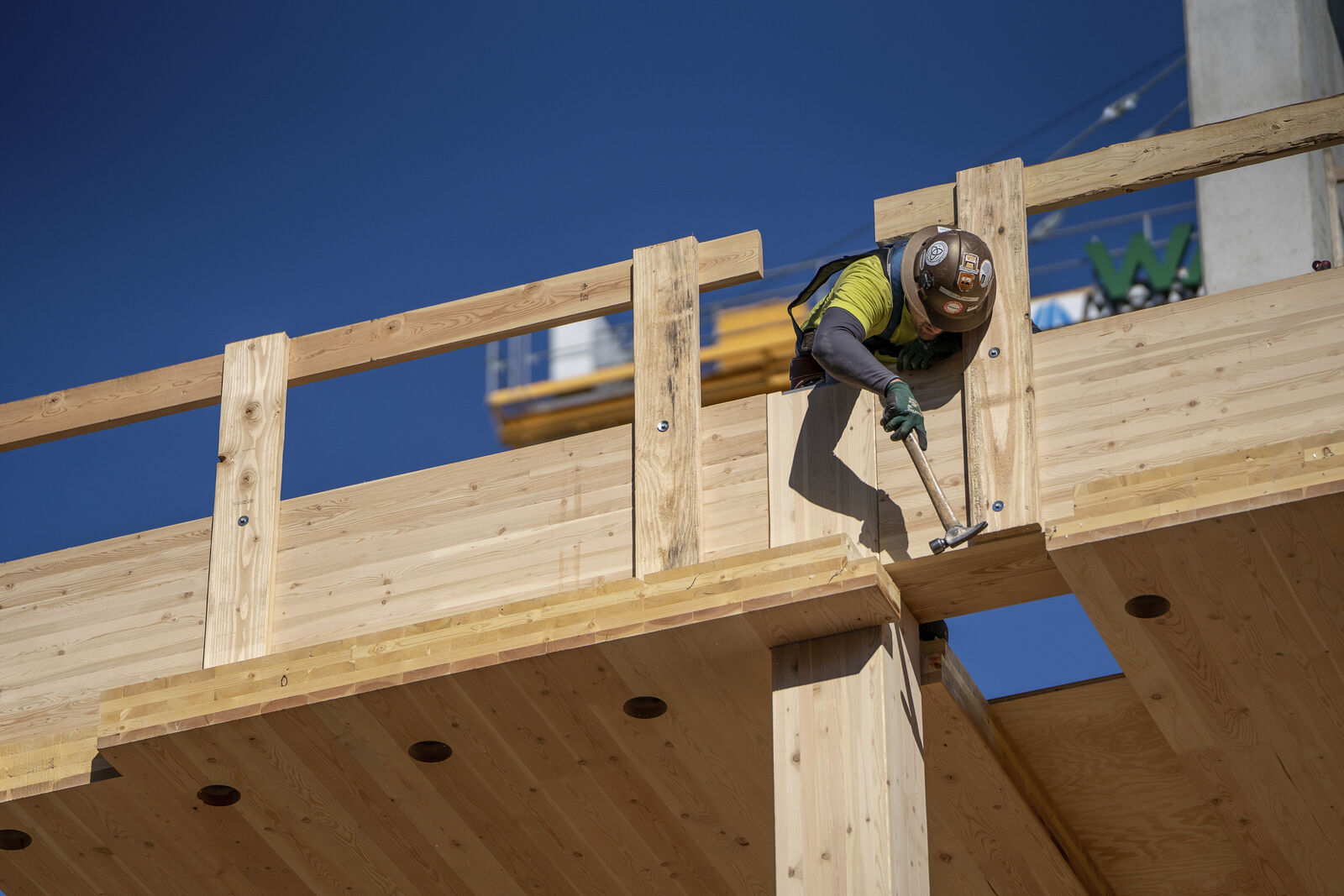 A construction worker on a floor of the PAE Living Building 