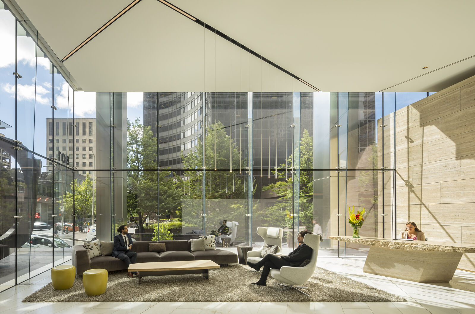 Photo of F5 Tower lobby with lounge furniture and front desk, looking out to 5th Avenue and Marion Sreet