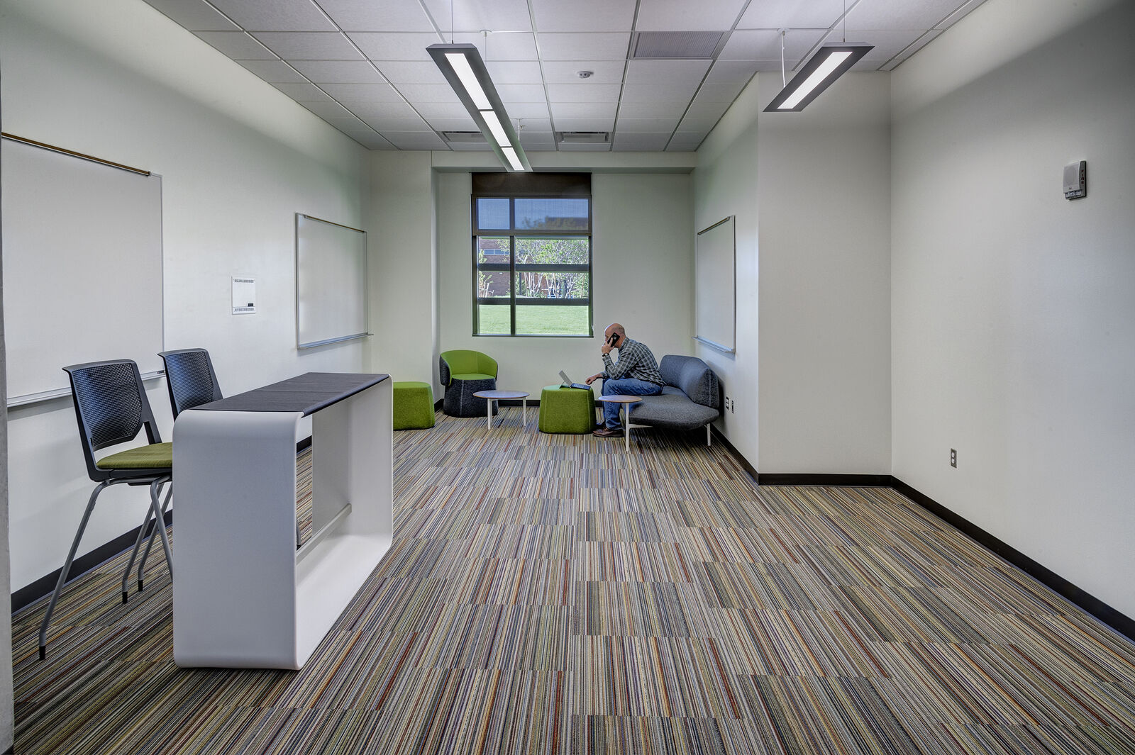 Man talking on phone in classroom area