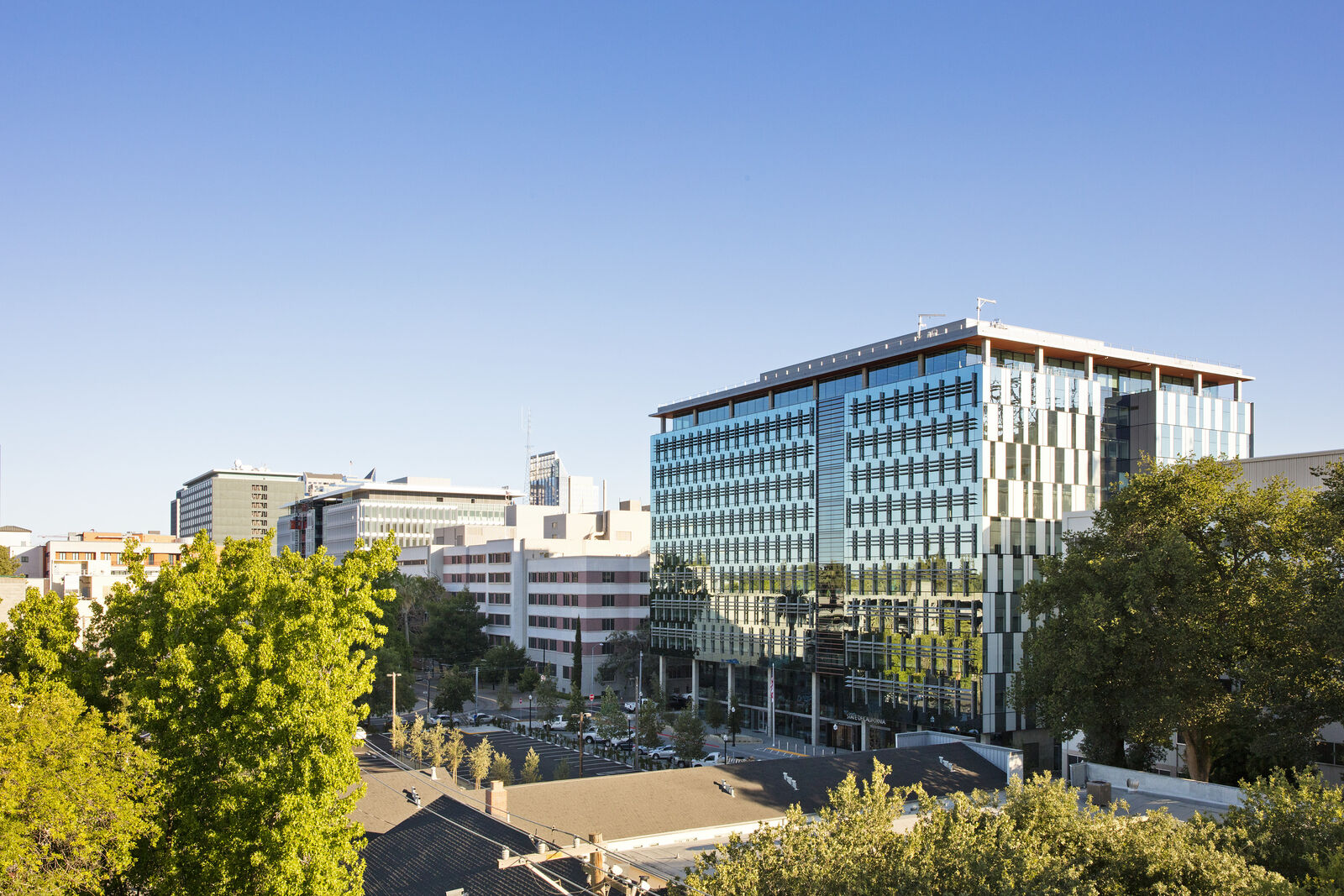 exterior shot of building along with other buildings and trees