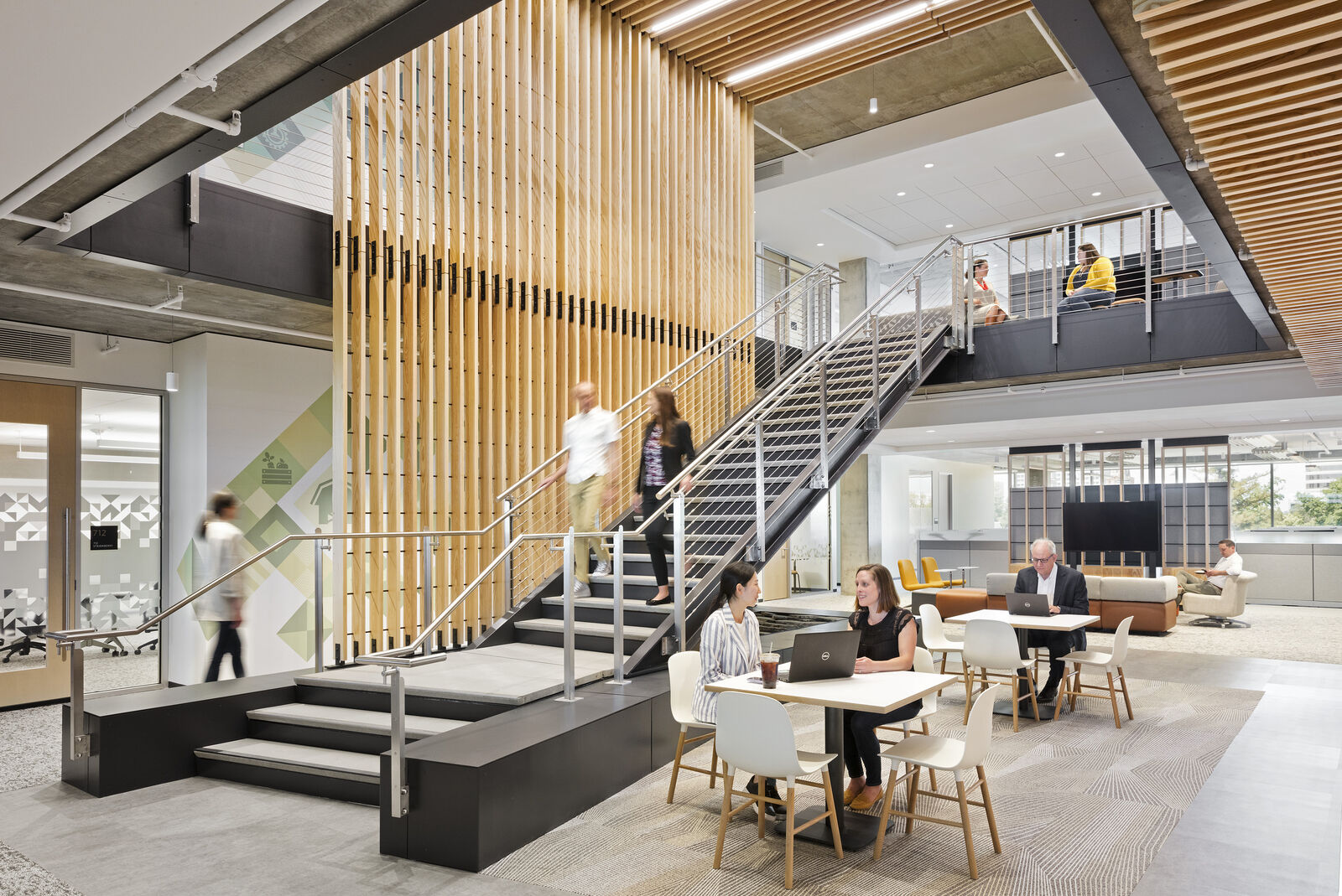 interior staircase and tables featuring people interacting with the environment 