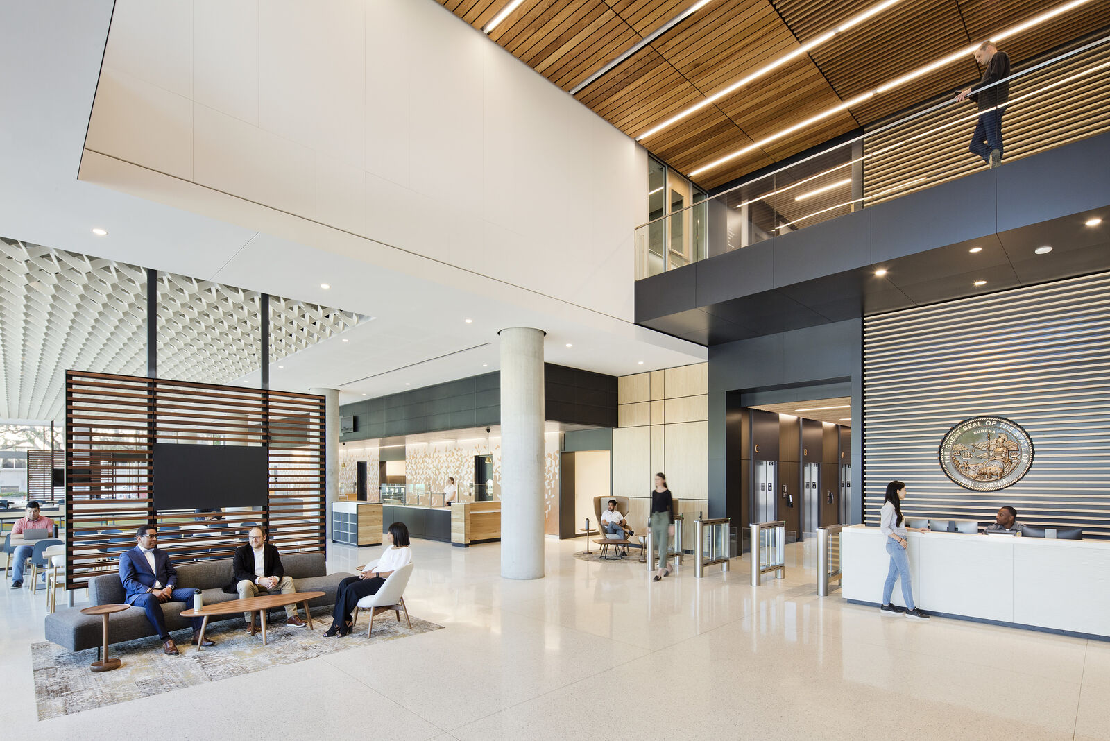 main interior lobby space with people moving and sitting 