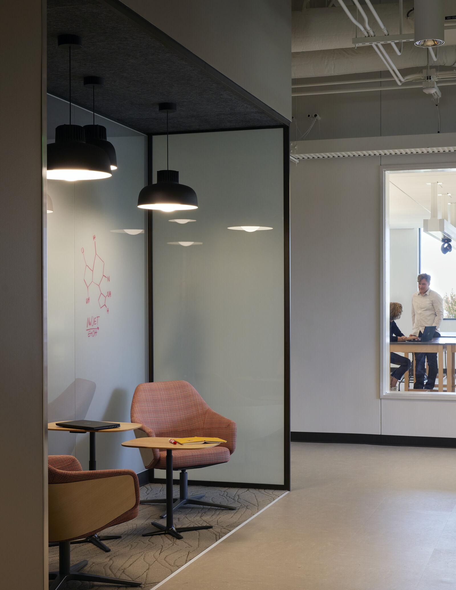 hallway meeting space with chairs and whiteboard 