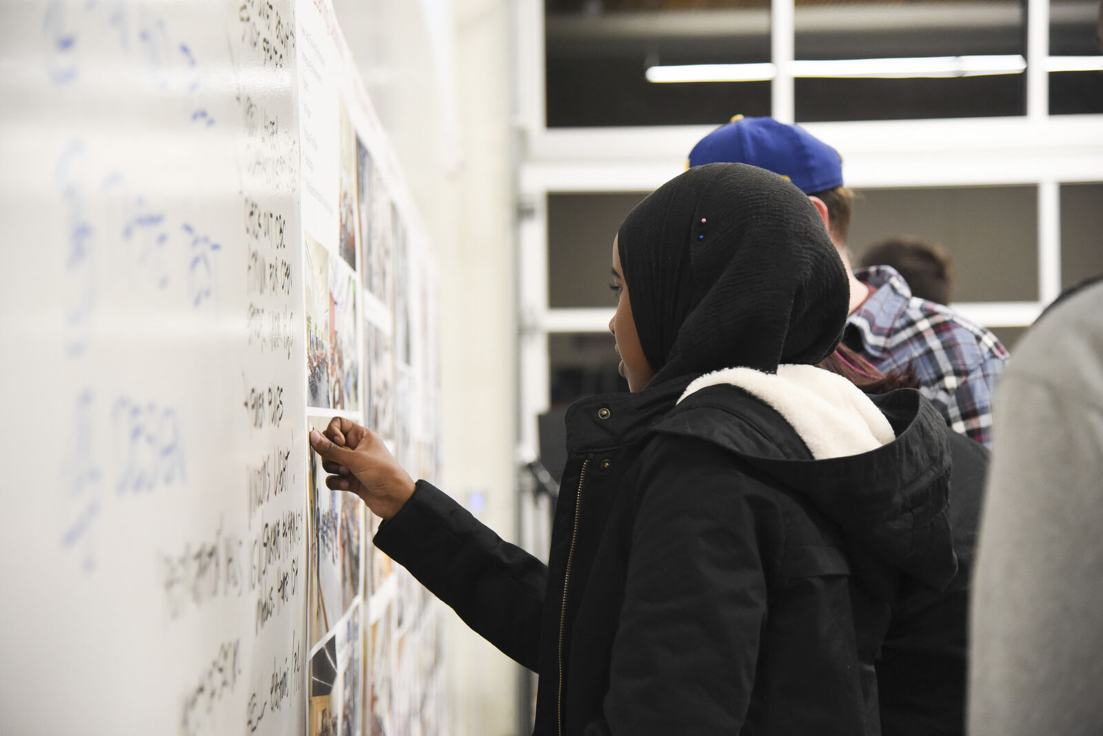 Woman writing on whiteboard 