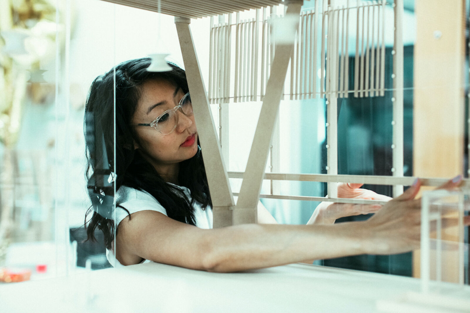 Woman working on wooden structure 